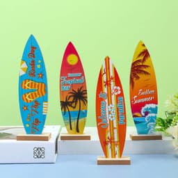 A collection of four colourful surfboard ornaments featuring tropical designs, displayed on wooden bases against a green background.