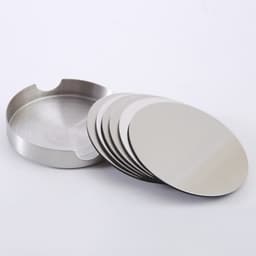 A set of stainless steel round coasters with a matching holder, featuring a shiny silver finish.