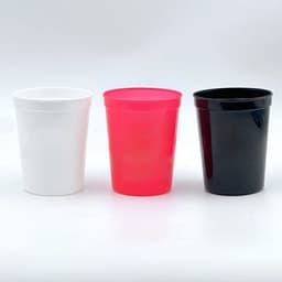 Three reusable plastic cups in white, pink, and black, all featuring a simple design and a logo.