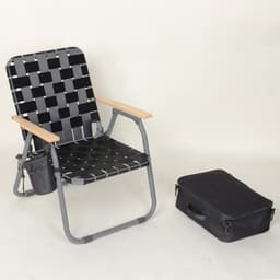 A folding webbed camping chair in black and grey, with wooden armrests, next to a black carrying bag.