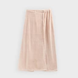 A women's adjustable bath wrap in a soft blush pink colour, featuring a textured fabric and an elastic band.