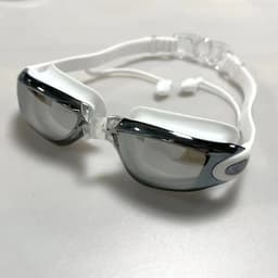 Unisex adult swimming goggles in white and black, featuring a sleek design and adjustable straps.
