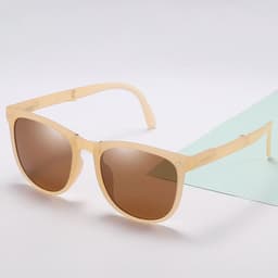 A pair of beige polarized folding sunglasses with brown lenses, displayed on a light background.
