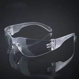Clear safety glasses with transparent lenses and clear frames, set against a dark background.