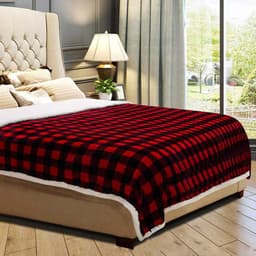 A custom double layer flannel blanket featuring a black and red check pattern, placed on a bed with a light-coloured headboard.