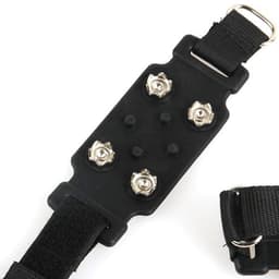 A pair of black heavy-duty anti-slip ice cleats with metal spikes attached to elastic straps for secure fitting.