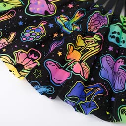 A vibrant black fan featuring colourful, glow-in-the-dark mushroom and floral designs, with a logo present.