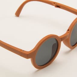 Personalised kids foldable sunglasses in a warm orange colour with dark lenses and rounded frames.
