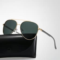 Polarised sunglasses with dark green lenses and a stylish gold frame, accompanied by a black felt storage bag.