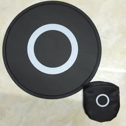 A black foldable flying disc fan with a circular design and a matching pouch, featuring a white circle pattern.