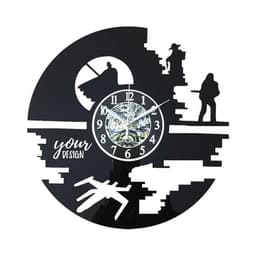 A black wall clock with intricate cut-out designs, featuring a clock face and a space for custom text.