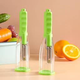 A pair of green peelers with transparent storage boxes, placed against a light background with fruits and vegetables.