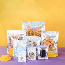 Holographic plastic ziplock bags in various sizes, containing snacks and small items, on a bright background.