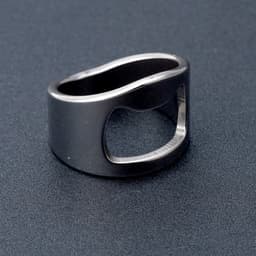 A drink bottle opener ring made of titanium steel, featuring a sleek, dark metallic finish and a unique design.