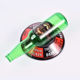 A green drink bottle placed on a round black and red spinner with various prompts and a logo.
