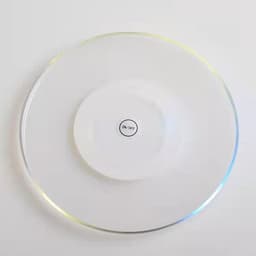 A clear LED coaster with a circular design and a white centre featuring an on/off switch.