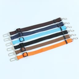 A set of retractable pet car seat belts in various colours, including blue, orange, brown, and black, each with a clip.