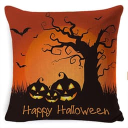A Halloween-themed pillow in orange and black featuring bats, a spooky tree, and carved pumpkins. It has a logo.