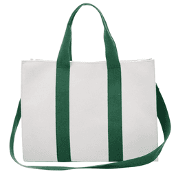A vertical stripe canvas tote bag in white with green handles and a matching shoulder strap. It has a logo.