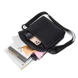 A black shoulder bag with various items, including notebooks, a phone, and sunglasses, partially visible inside.