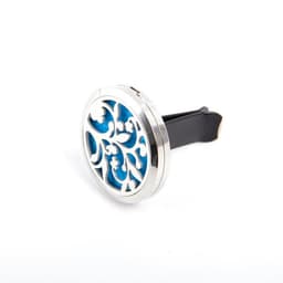 A circular car essential oil vent clip featuring intricate silver detailing and a blue background. It has a black clip attachment.