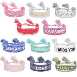 A collection of adjustable embroidery tassel bracelets in various colours, featuring words like "Love," "Lucky," and "Good Vibes."