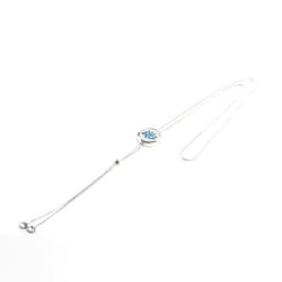 A stainless steel hollow aromatherapy pendant necklace with a silver chain and a decorative centrepiece.