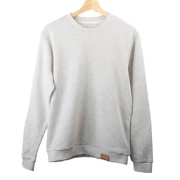 A light grey crew neck sweatshirt hanging on a wooden hanger, featuring a small logo on the hem.