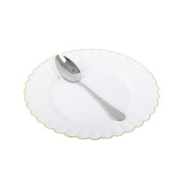A stainless steel dinner spoon rests on a white plate with a gold scalloped edge. The spoon has a sleek, polished finish.