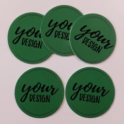 A set of five round green coasters featuring a black logo with the text "your design."
