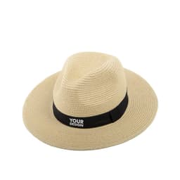 A wide brim Panama hat in straw colour with a black band featuring a logo.