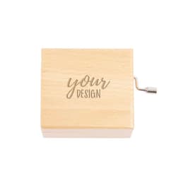 A wooden hand crank music box with a smooth finish and an engraved design on the lid.