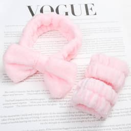 A pink spa headband and matching wrist washbands made of soft, fluffy material, presented on a magazine page.