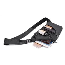 A grey crossbody sling bag with multiple compartments, featuring a strap, and containing a phone, wallet, and other items.
