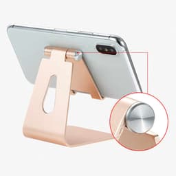 An adjustable aluminium phone and tablet stand in a rose gold finish, displaying a smartphone.