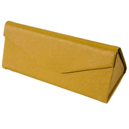 A triangular folding glasses case in a textured mustard yellow finish, featuring an envelope-style design and a logo.