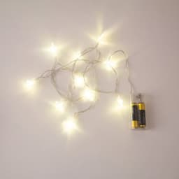A string of warm white LED star lights with a battery pack, featuring a silver wire design.