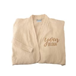 A beige long cotton bathrobe features a soft texture and an embroidered design area, folded neatly.