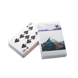 A deck of playing cards featuring a design with spades and a mountain scene on the box. The cards have a white background.