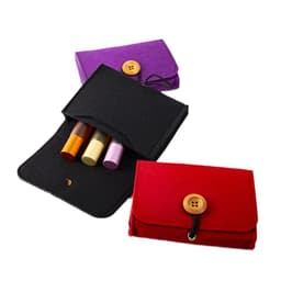 A black, purple, and red felt pouch with a button closure, containing essential oil bottles in various shades.
