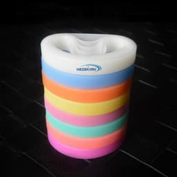 A stack of silicone rubber wristbands in various colours including pink, orange, blue, and green. The item features a logo.
