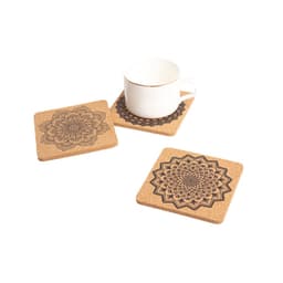 A set of square cork coasters displaying intricate mandala designs, accompanied by a cup.