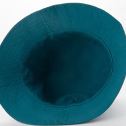 A teal bucket hat featuring a simple design and an internal lining. The hat has a solid colour and no visible logos.