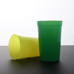 A green and a yellow 16 oz. custom plastic stadium cup, featuring a simple design and a logo.