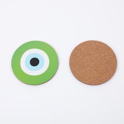 A green and white patterned drink coaster alongside a plain cork coaster. Both are round in shape.