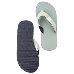 A pair of grey beach flip flops with a light green strap, featuring a textured black sole and a logo on the strap.