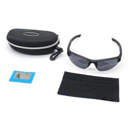 A pair of black outdoor sports sunglasses, a cleaning cloth, and a patterned black case with a logo.