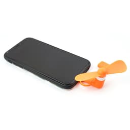 An orange mini fan sits beside a black smartphone, designed for USB connection. It has a small, propeller-like shape.