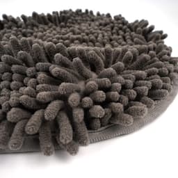 A grey pet towel with raised, textured fibres and hand pockets for easy use. It features a logo on the fabric.