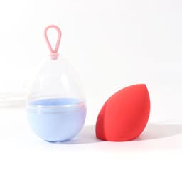 A pink lanyard holds a blue container next to a red beauty egg, designed for hair and beauty use.